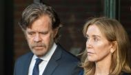 In this file photo taken on September 13, 2019, actress Felicity Huffman, escorted by her husband actor William H. Macy, exits the John Joseph Moakley United States Courthouse in Boston, where she was sentenced by Judge Talwani for her role in the College