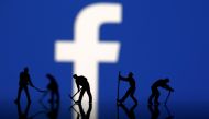 FILE PHOTO: Figurines are seen in front of the Facebook logo in this illustration taken March 20, 2018. REUTERS