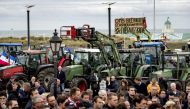 Dutch farmers gather beside their tractors at the Hotel van Oranje in Noordwijk on October 26, 2019, to demand that their views be heard on the popular Dutch television program 