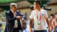 Guangzhou R&F head coach Dragan Stojkovic (L) speaking with translator Hong Wenjie during their Chinese Super League football match with Shandong Luneng in Guangzhou in China's southern Guangdong province on October 19, 2019. AFP