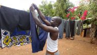 Moses Njiru hangs laundry to dry at his home in Ishiara, in Kenya's Embu County, October 12, 2019. Thomson Reuters Foundation/Carorline Wambui