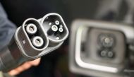 A man holds DC-power charging plug of his BMW i3 electric car during the presentation of a new super-fast multi-charging power column comfort charge belonging to Deutsche Telekom. Reuters / Wolfgang Rattay