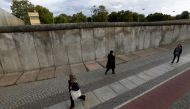 File photo of people walking along the remains of Berlin Wall at the Berlin Wall memorial on Bernauer Strasse in Berlin, Germany, September 19, 2019.  REUTERS/Fabrizio Bensch