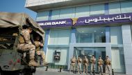 Lebanese army soldiers stand guard outside a branch of Byblos Bank in the southern city of Sidon, Lebanon November 4, 2019. REUTERS/Ali Hashisho