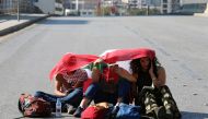 Demonstrators sit on the ground and read along a blocked road during ongoing anti-government protests in Beirut, Lebanon November 4, 2019. REUTERS/Mohamed Azakir