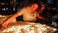 Israelis light candles during a rally to mark the 24nd anniversary of the assassination of former Israeli prime minister Yitzhak Rabin at Rabin Square, in the coastal city of Tel Aviv on November 2, 2019.  AFP / Jack Guez
 