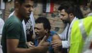 Iraqi paramedics aid an injured protester following clashes with security forces on al-Ahrar bridge in the capital Baghdad during ongoing anti-government demonstrations on November 4, 2019. AFP / Ahmad Al-Rubaye
 