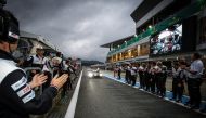 GAZOO Racing team members applaud as the No. 8 TS050 Hybrid Electric  Vehicle  arrives  at  the  pit after winning the 6 Hours of Fuji Race at the Fuji Speedway. 