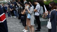 A woman weeps as she attends a gathering to pay tribute to Chow Tsz-lok, 22, a university student who fell during protests at the weekend and died early on Friday morning, in Hong Kong, China November 8, 2019. REUTERS/Ahmad Masood
 
