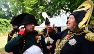 (FILES) This file photo taken on June 18, 2015 shows French lawyer Franck Samson, dressed as Napoleon Bonaparte (L) speaking with Russian historian Oleg Sokolov (R) during commemorations marking the 200th anniversary of The Battle of Waterloo in Waterloo.