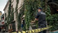 A Turkish police officer stands guard outside the Mayday Rescue offices on November 11, 2019, in the Karakoy district of Istanbul, following the discovery of the body of the organisation's founder. AFP / Bulent Kilic 