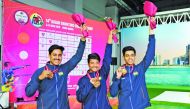 Dhanush Srikanth (centre) celebrates his gold medal with other medal winning shooters yesterday.
