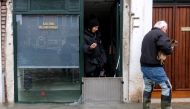 A man with his dog walks past an art gallery during exceptionally high water levels in Venice, Italy November 13, 2019. REUTERS/Manuel Silvestri