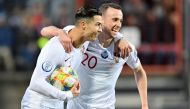Portugal's forward Cristiano Ronaldo (L) celebrates after scoring a goal during the UEFA Euro 2020 Group B qualification football match between Luxembourg and Portugal at the Josy Barthel Stadium in Luxembourg on November 17, 2019. / AFP / John Thys 