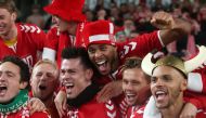 Denmark's players celebrate qualifying for the finals on the pitch after the Group D Euro 2020 football qualification match between Republic of Ireland and Denmark at Aviva Stadium in Dublin, Ireland on November 18, 2019. The game finished 1-1, Denmark qu