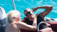 Barack Obama and Richard Branson sit on a boat on Moskito island the British Virgin Islands in a picture handed out by Virgin on February 7, 2017 via Reuters