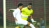 Qatar’s Akram Afif vies for the ball possession with Afghanistan goalkeeper Ovays Azizi.