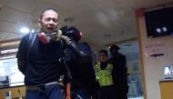 Riot police detain a protester and a medic during pre-dawn police operations at Hong Kong Polytechnic University (PolyU), Hong Kong, China November 18, 2019, in this still image obtained from a social media video. PolyU Campus Radio/via Reuters