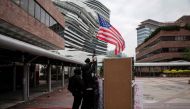 Protesters raise a US flag inside the Hong Kong Polytechnic University in the Hung Hom district of Hong Kong on November 20, 2019. AFP / NICOLAS ASFOURI