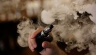 FILE PHOTO: A man holds an electronic cigarette as he vapes at a vape Shop in Monterrey, Mexico February 1, 2019. Picture taken February 1, 2019. FREUTERS/Daniel Becerril/File Photo
