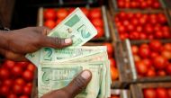 A man counts bond notes near a vegetable market in Harare, Zimbabwe, January 23, 2019. Reuters / Philimon Bulawayo