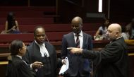 Advocate Muzi Sikhakhane (2ndL), part of former South African President Jacob Zuma's legal team, speaks to advocate Anton Katz (R), legal representative of the French Defence company Thales, before the trail of South Africa's embattled former president Ja
