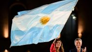 Argentine President Mauricio Macri applauds as First Lady Juliana Awada was a national flag during the closing rally of his campaign in Cordoba, Argentina, on October 24, 2019. AFP / Ronaldo Schemidt