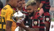 Flamengo's Gabriel Barbosa holds the trophy after winning the Copa Libertadores final football match by defeating Argentina's River Plate, at the Monumental stadium in Lima, on November 23, 2019. / AFP / CRIS BOURONCLE