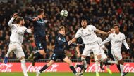 Real Madrid's French forward Karim Benzema (2R) prepares to shoot and score a goal during the Spanish league football match Real Madrid CF against Real Sociedad at the Santiago Bernabeu stadium in Madrid on November 23, 2019. / AFP / PIERRE-PHILIPPE MARCO