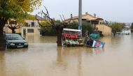A car and gas tanks sit in water in a flooded area after heavy rains in Le Muy, southeastern France, on November 24, 2019.   AFP / Valery HACHE
