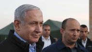 Israel's Prime Minister Benjamin Netanyahu (L) and Defence Minister Naftali Bennett (2nd) visit an army base in the Israeli-annexed Golan Heights overlooking Syrian territory, on November 24, 2019. AFP / Atef Safadi
 