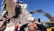 Rescue workers remove debris from a collapsed building in Thumane, northwest of capital Tirana, after an earthquake hit Albania, on November 26, 2019.  AFP / Armend NIMANI
