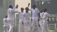 West Indies' Rahkeem Cornwall (L) celebrates with teammates after dismisssing Afghanistan's Ibrahim Zadran (not pictured) during the international Test cricket match between Afghanistan and West Indies at the Ekana Cricket Stadium in Lucknow on November 2