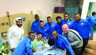Qatari players and officials with injured Bassam Al Rawi. Picture: Twitter / @alkasschannel