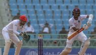 West Indies' Carlos Brathwaite (R) plays a shot during the first day of an international Test cricket match between Afghanistan and West Indies at the Ekana Cricket Stadium in Lucknow on November 27, 2019. IMAGE RESTRICTED TO EDITORIAL USE - STRICTLY NO C