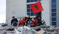 Emergency personnel put an Albanian flag on top of rubble, on the occasion of the Albanian Independence Day, during a search for survivors in a collapsed building in Durres, after an earthquake shook Albania, November 28, 2019. Reuters/Florion Goga
