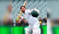 Pakistan batsman Yasir Shah celebrates scoring his century against Australia on the third day of the second cricket Test match in Adelaide on December 1, 2019. AFP / William West 