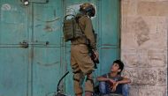 An Israeli soldier detains a Palestinian boy during an anti-Israel protest in Hebron in the Israeli-occupied West Bank November 29, 2019. Reuters/Mussa Qawasma
 
 