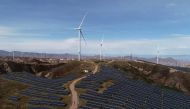 Wind turbines and solar panels are seen at a wind and solar power plant by State Power Investment Corporation in Zhangjiakou, Hebei province, China, October 29, 2018. Reuters