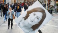 A person walks with a picture of Daphne Caruana Galizia during a demonstration to demand justice over the murder of the journalist, in Valletta, Malta, December 1, 2019. Reuters/Yara Nardi 