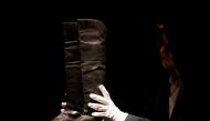 Boots that might have be worn by French statesman Napoleon during his final exile in Saint-Helena are handled before being put on auction at Drouot auction house in Paris, November 28, 2019. Reuters/Christian Hartmann