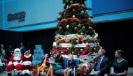 US First Lady Melania Trump reads excerpts from the book 'Oliver the Ornament Meets Belle,' by author Todd Zimmerman, as patients Sammie Burley (L) and Declan McCahan (R) listen, during her visit to the Children's National Hospital, in Washington, U.S. De