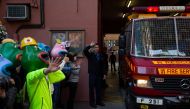 People wearing masks depicting Pepe the Frog, a character used by pro-democracy activists as a symbol of their struggle, make way for a fire truck to exit before the 'Human Rights Day' rally from Victoria Park to Chater Road in Hong Kong on December 8, 20