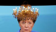 A chandelier hangs in front of a giant TV screen showing German Chancellor Angela Merkel on September 03, 2017. AFP / dpa / Kay Nietfeld