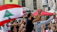 FILE PHOTO: Lebanese protesters celebrate the resignation of Saad Hariri in the southern city of Sidon on October 29, 2019 on the 13th day of anti-government protests. AFP / Mahmoud Zayyat