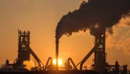 The sun rising above Tata Steels blast furnaces at their Scunthorpe Plant in north east England. AFP file photo / Lindsey Parnaby