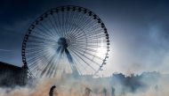 People stand amid tear-gas smoke during a demonstration on December 10, 2019 in Lyon as part of the sixth day of massive strike action over government's plans to overhaul the pension system. AFP / Jeff Pachoud
 