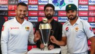 Pakistan's captain Azhar Ali (R) and his Sri Lankan counterpart Dimuth Karunaratne (L) pose for a photograph with Test series trophy at the Pindi Cricket Stadium ahead of the first Test cricket match between Pakistan and Sri Lanka in Rawalpindi on Decembe