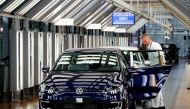 FILE PHOTO: A worker makes final checks on an e-Golf electric car at the new production line of the Transparent Factory of German carmaker Volkswagen in Dresden, Germany, March 30, 2017. REUTERS/Fabrizio Bensch/File Photo
