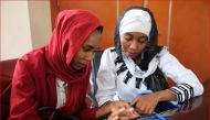 Entrepreneurs Falmata Awada and Zam-zam Djorkode give a demonstration of their mobile health app in N'Djamena, Chad, November 21, 2019. Thomson Reuters Foundation/Nellie Peyton